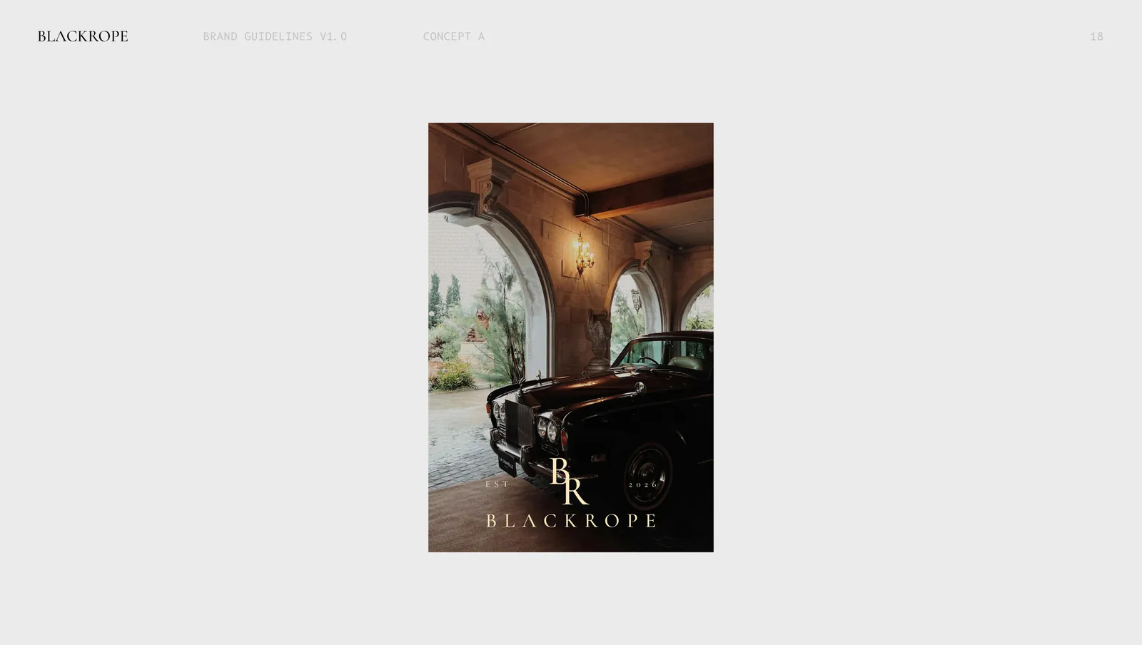 Concept one on a poster, a vintage car under a stone arch with the mark set below.